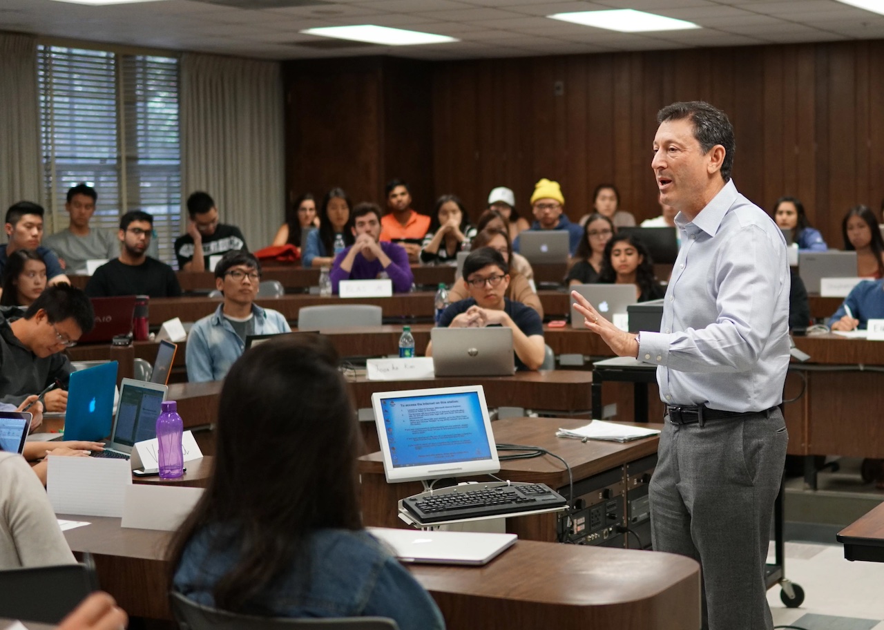 Economics professor giving a lecture to students